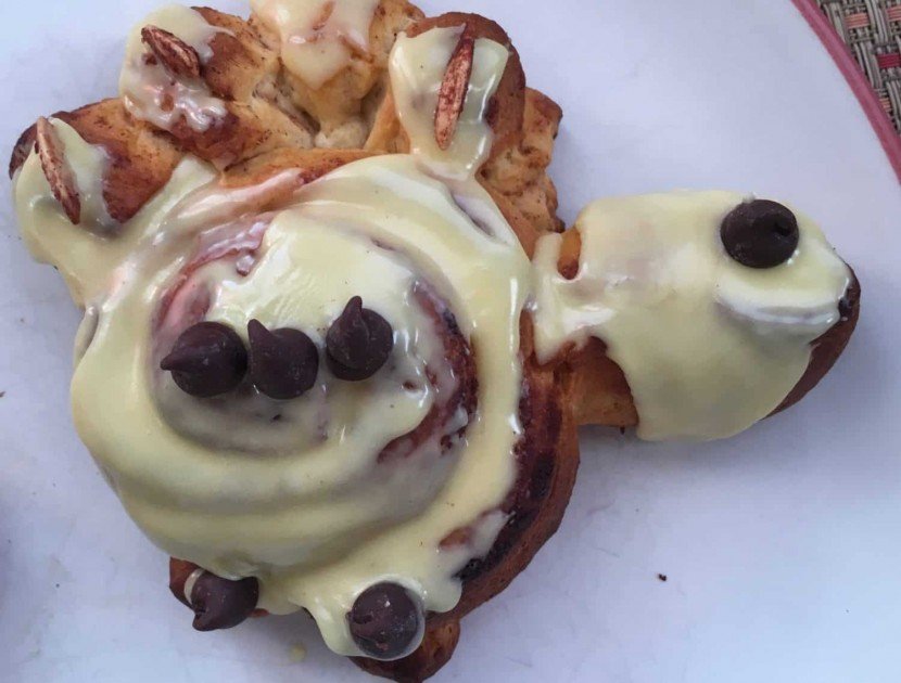Cinnamon Roll in shape of turkey with icing on body and head and chocolate chips for an eye and to outline the wing.