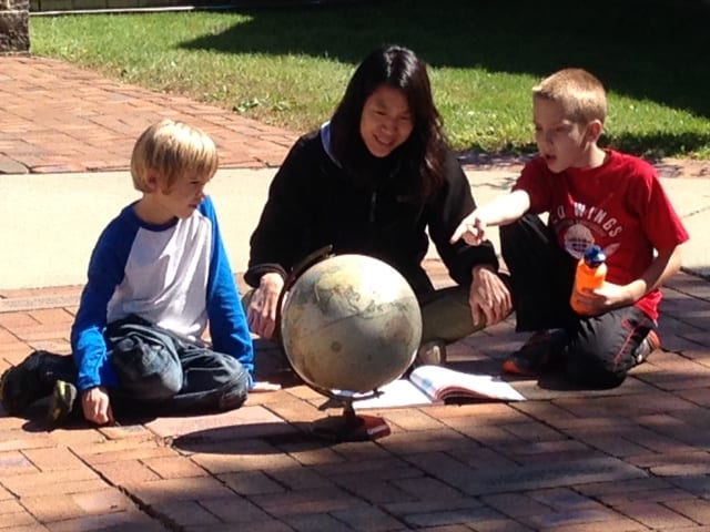 Clonlara School - Students and teacher explore a globe