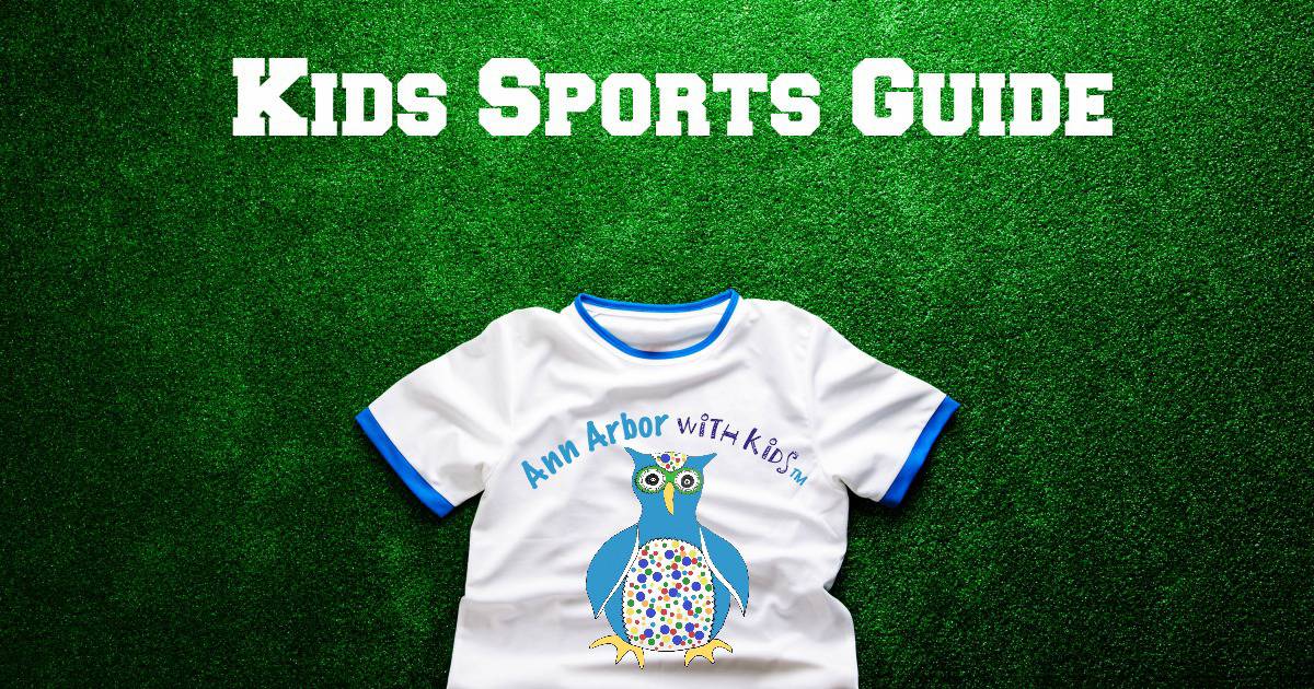 Ann Arbor Kids Sports Guide - sports t-shirt sporting Ann Arbor with Kids logo laying on a grass field sporting
