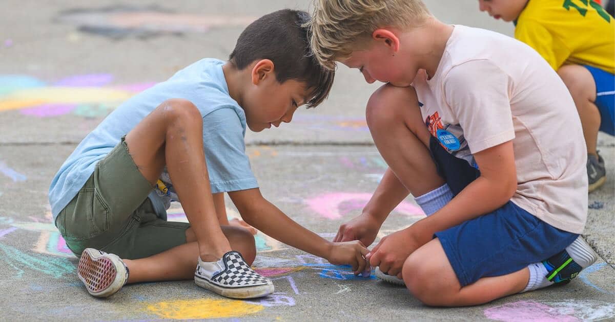 Sidewalk Chalk Day - 2 kids create chalk art on the sidewalk