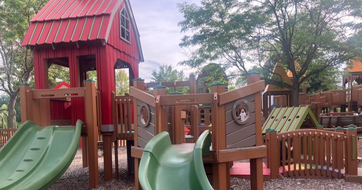 Timbertown - tot play structure with slides, barn representing Chelsea Fair, and bridge