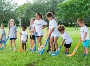 Kidokinetics - a line of kids line up golf shots