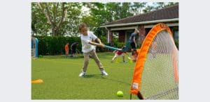 Kidokinetics - Boy hitting Golf ball into a net