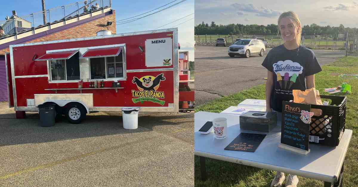 AFC Ann Arbor - Tacos Al Panda Food Truck and Washtenaw Dairy employee standing at an employee. A chalk sign indicates the flavors: Mint Chip, Superman, Vanilla, Chocolate, Mackinac Fudge, Lemon Sorbet. There's another chalk board on the table that describes the Mighty Oak ice cream - only available at AFC Ann Arbor games. Also on the table is a phone for payment, a tip jar, and a money lockbox. A crate holds a paper bag and coolers are behind the table.