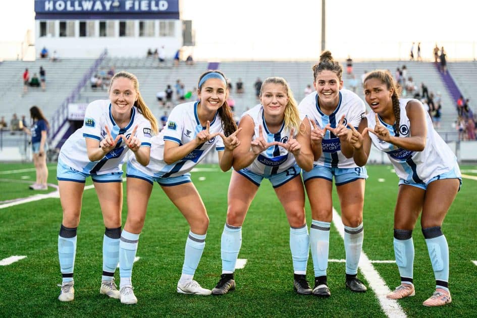 AFC Ann Arbor Women's Team makes a "W" symbol with their hands