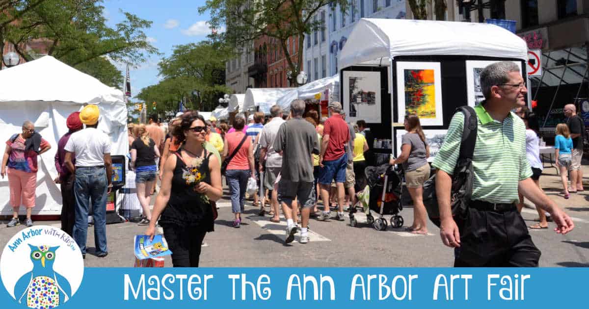 Master the Ann Arbor Art Fair - People browsing tents setup along Main St at Art Fair