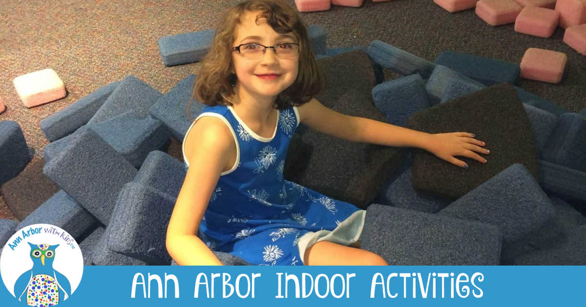 Indoor Kids Activities Near Ann Arbor - Girl sitting among foam blocks