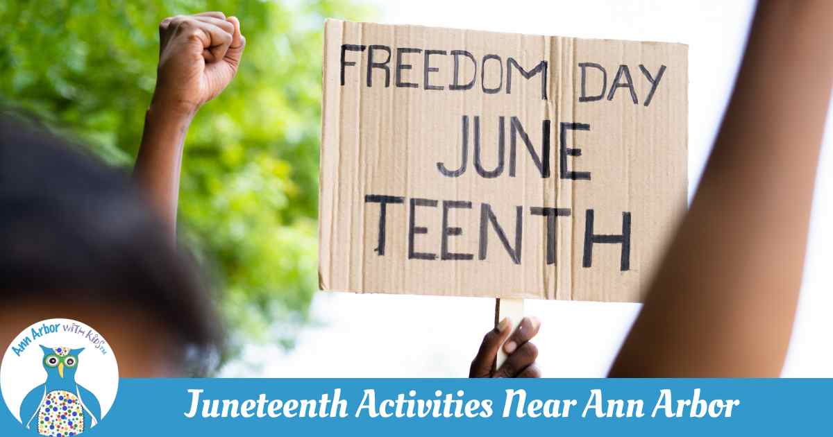 Juneteenth Activities Near Ann Arbor - raised fists with tree behind and sign that says Freedom Day - June Teenth