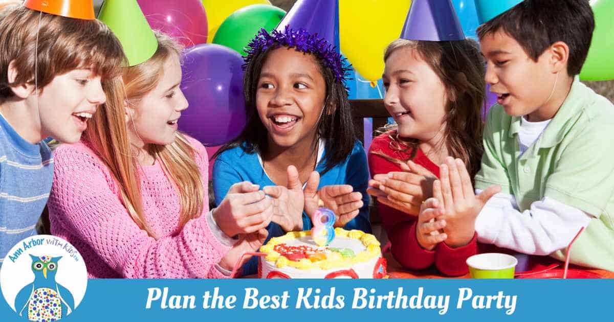 Plan the Best Kids Birthday Party - kids celebrating a birthday wearing hats & cake with balloons behind them.