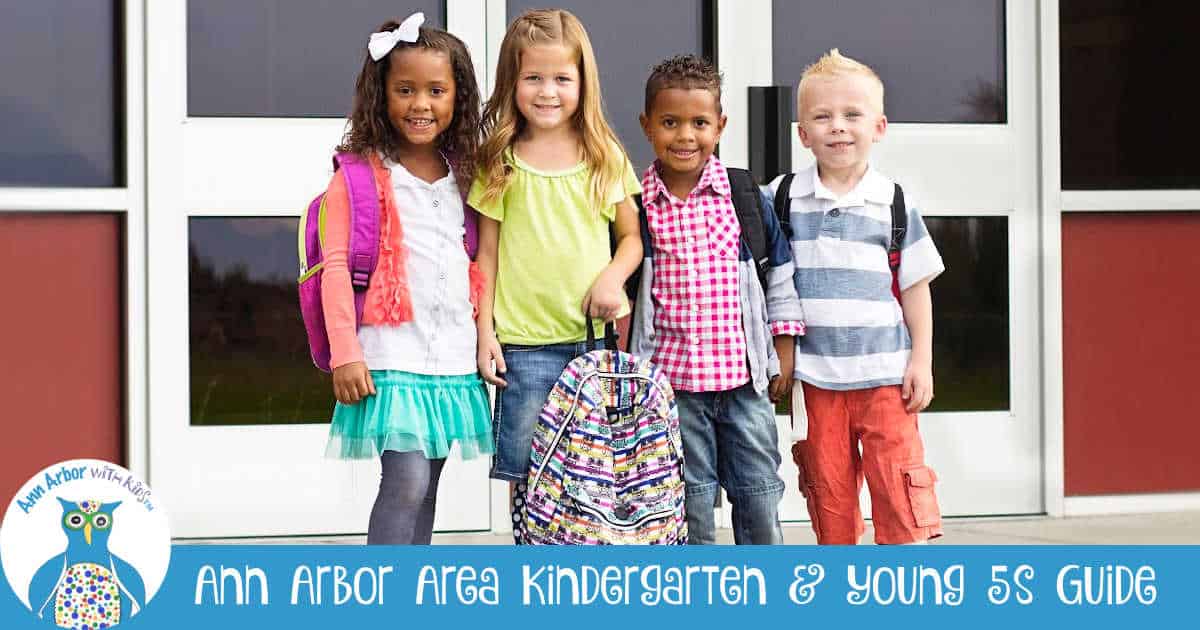 Ann Arbor Kindergartens & Young 5s Guide - 4 kindergartners stand in front of a school with backpacks