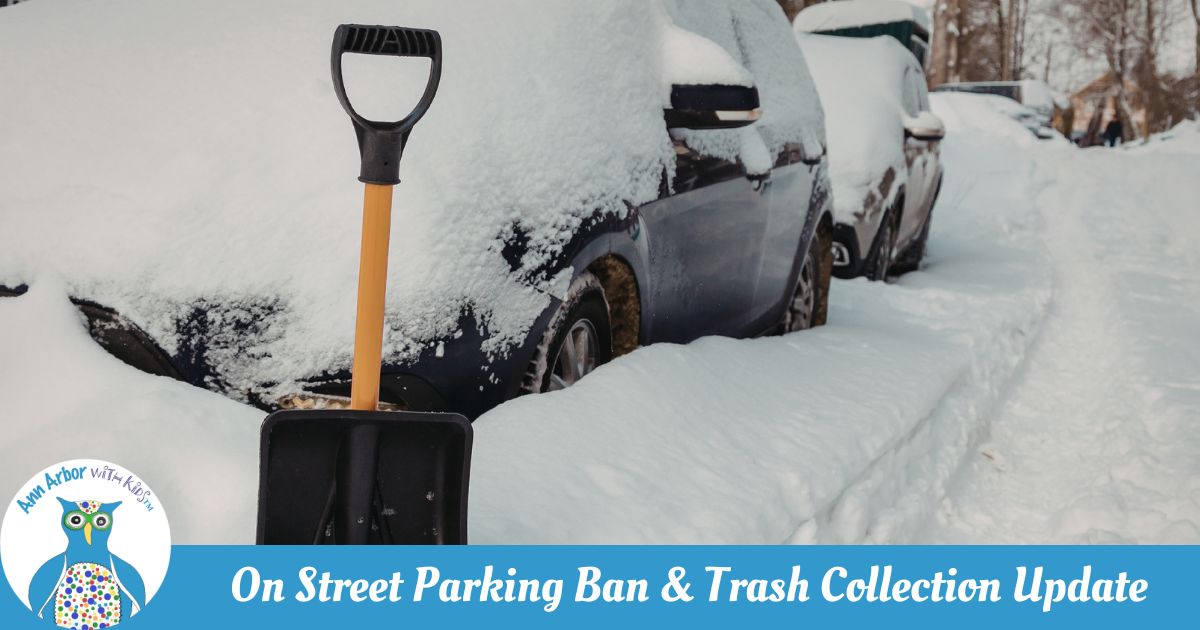 On Street Parking Ban & Trash Collection - Cars covered in snow and plowed in parked along the street. A snow shovel in the foreground