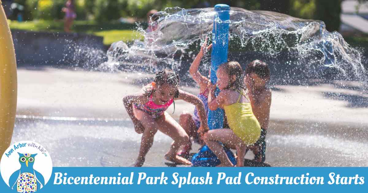 Bicentennial Splash Pad Construction Starts - stock photo of kids in swim suits gathered under a pole that emits an umbrella of water