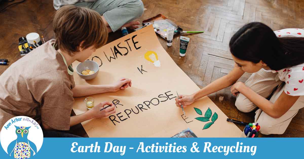 Earth Day Activities & Recycling - kids work on a paper sign promoting Zero Waste, Repurpose, & with leaves and a lightbulb