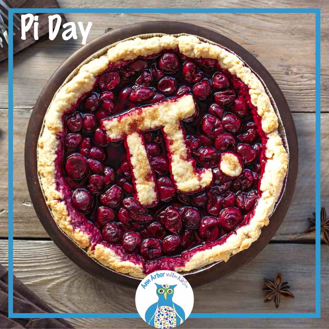 Pi Day - a wooden table with a cherry pie on top. Instead of a full top crust, there is a cut out of the symbol Pi