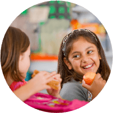 School Lunch - Two girls sharing laughs during lunch