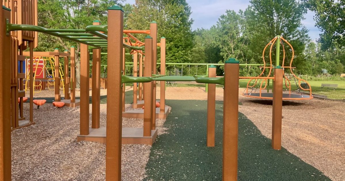 Timbertown - monkey bars, climber and swings in background