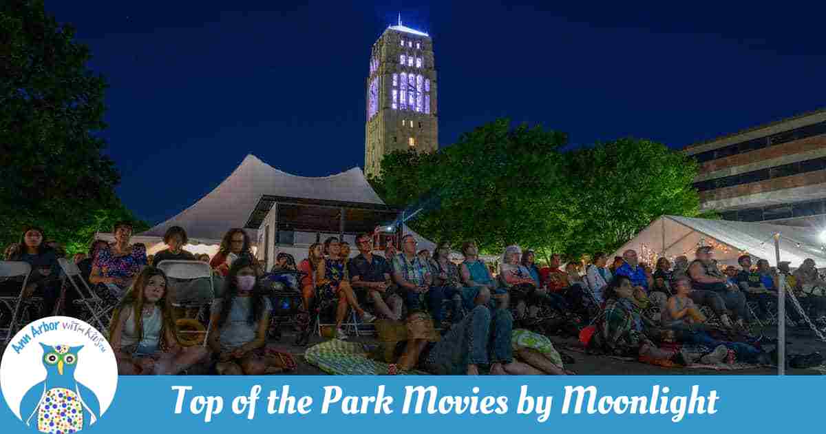 Top of the Park Movies by Moonlight - People sitting in front of the Bell Tower watching a movie