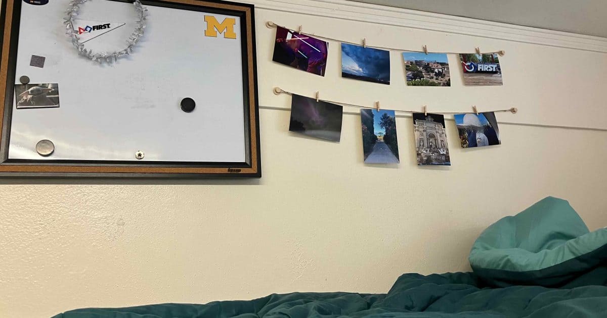 Next to the loft bed with bulletin board and picture strings.